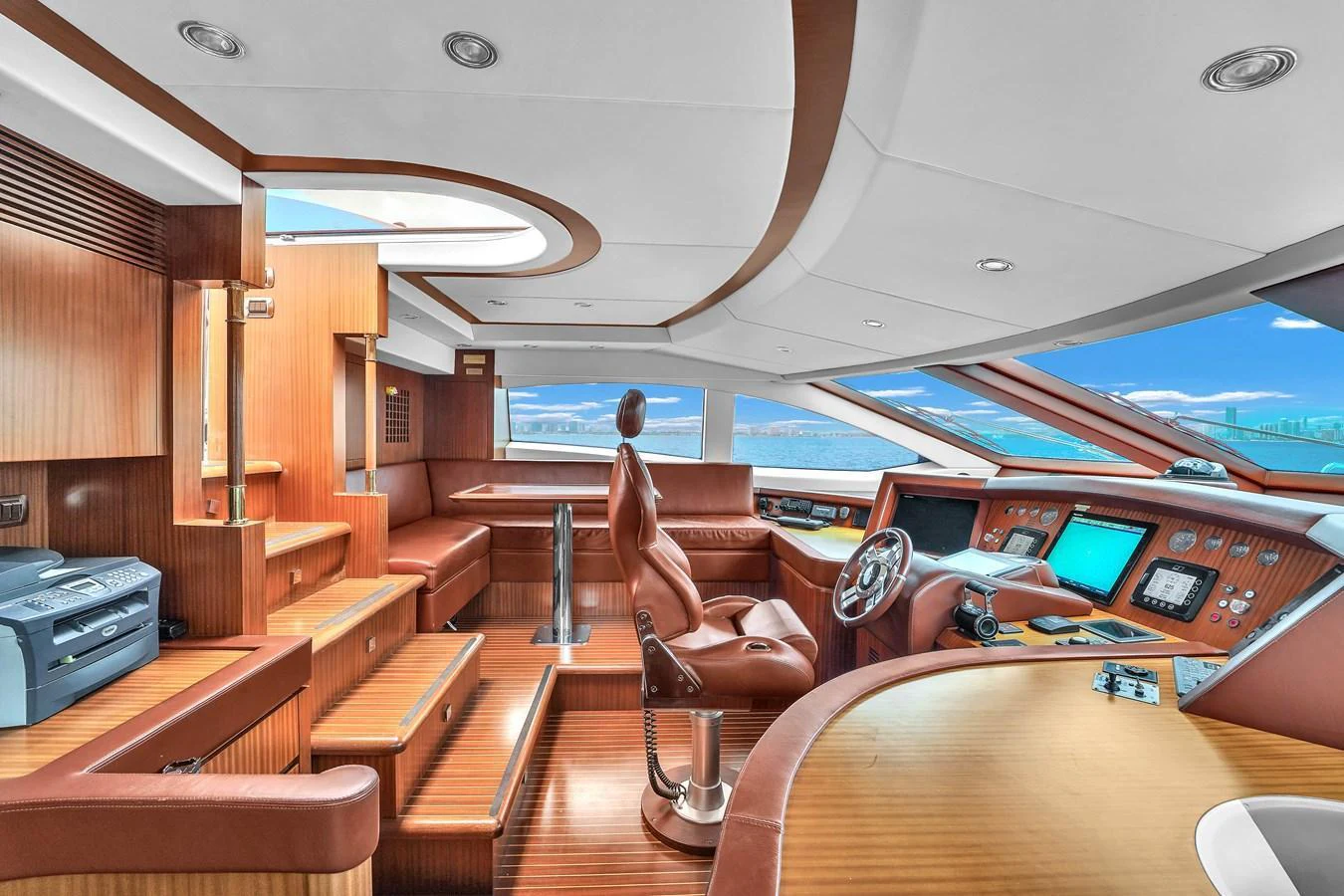 The helm station features luxurious wood finishes and state-of-the-art navigation equipment. aboard AZIMUT GRANDE 105 Yacht for Sale