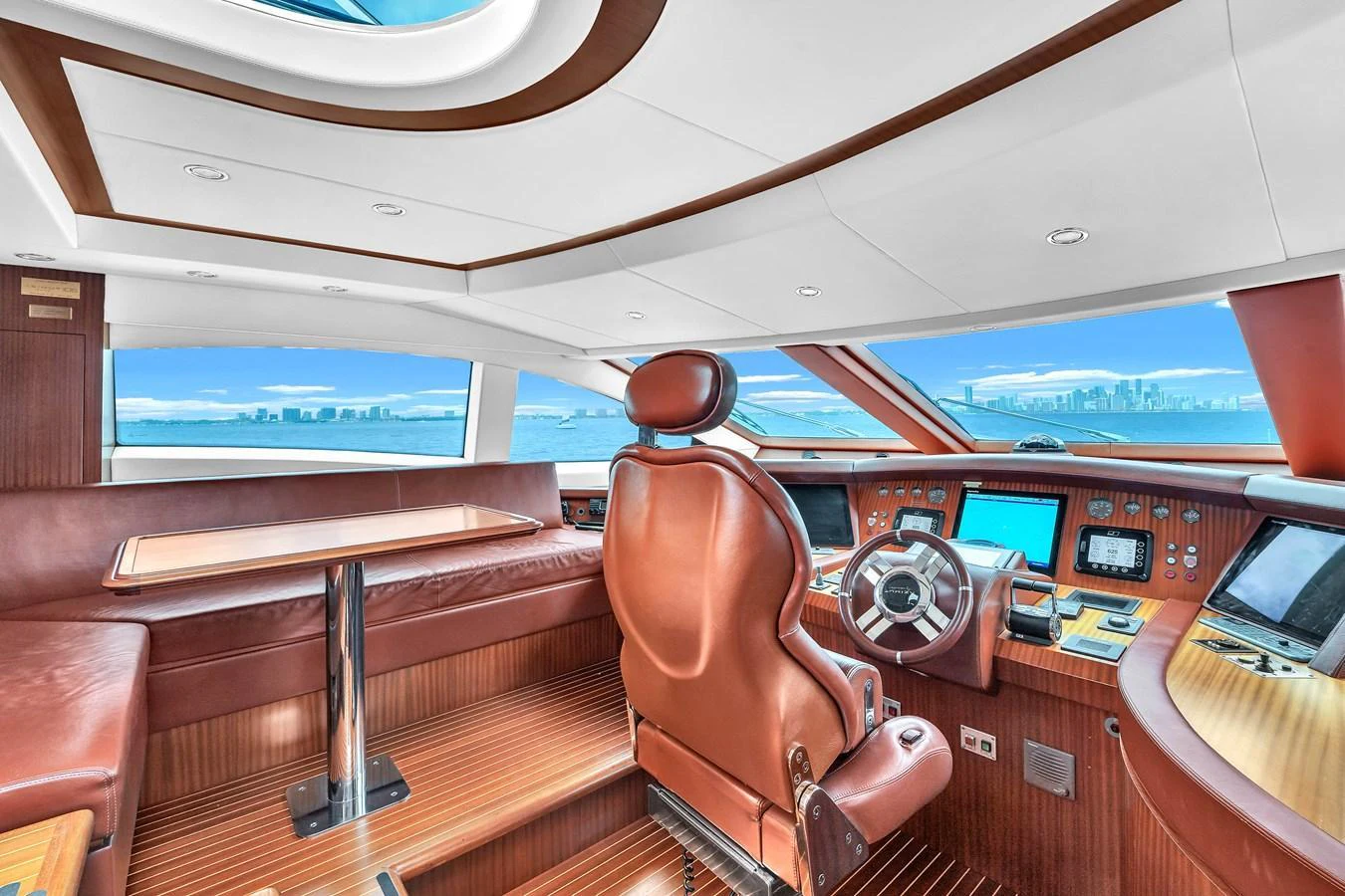 The helm station features luxurious leather seating and state-of-the-art navigation equipment with panoramic views. aboard AZIMUT GRANDE 105 Yacht for Sale