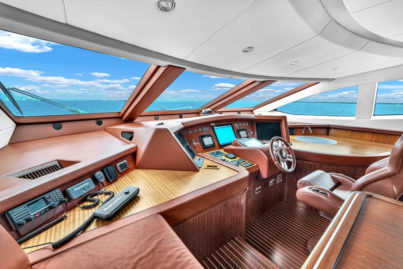 The helm station offers a commanding view with state-of-the-art navigation equipment and luxurious seating. aboard AZIMUT GRANDE 105 Yacht for Sale