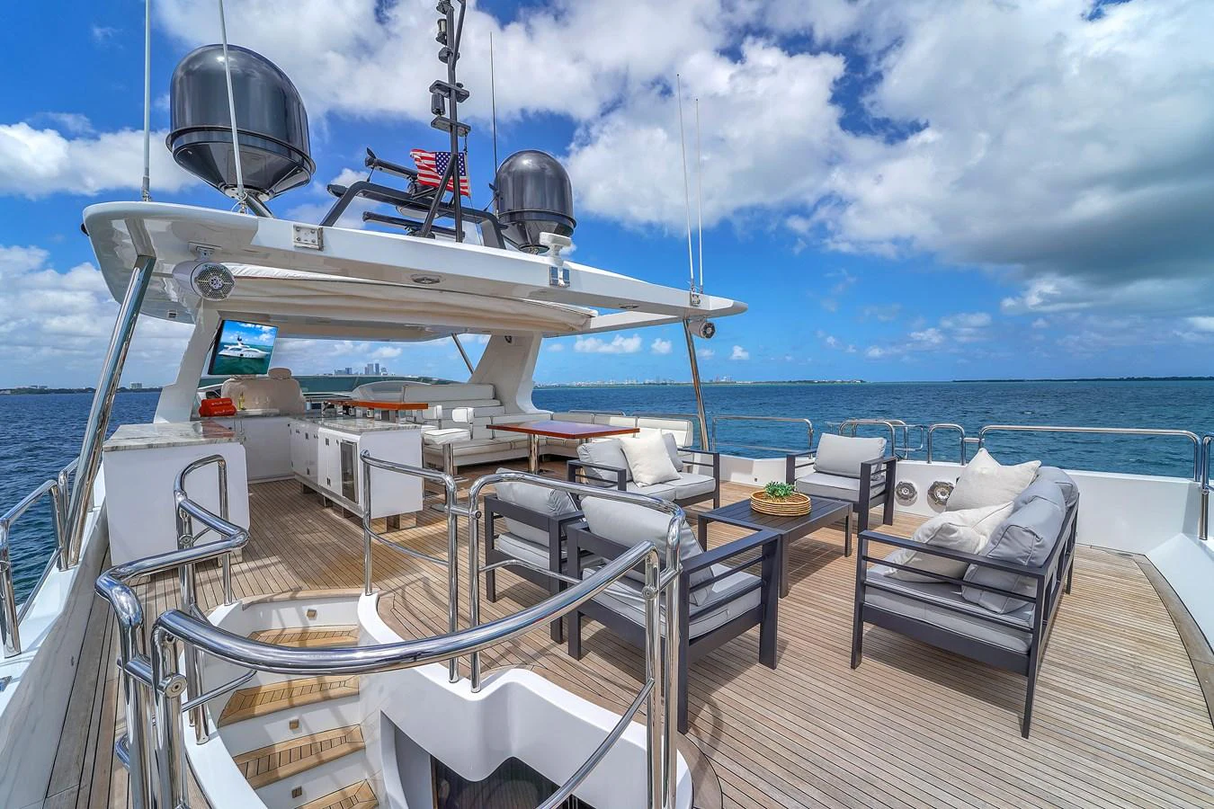 The flybridge offers a spacious and comfortable outdoor lounging area with stunning sea views. aboard AZIMUT GRANDE 105 Yacht for Sale