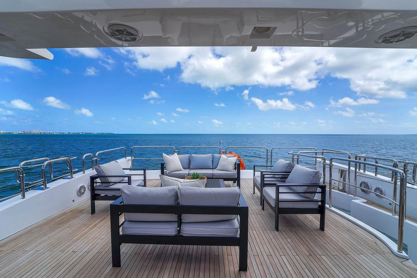 The aft deck offers a luxurious seating area with stunning ocean views. aboard AZIMUT GRANDE 105 Yacht for Sale