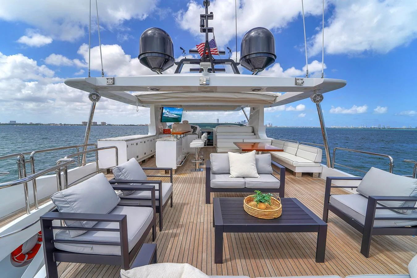 The aft deck offers a spacious and comfortable outdoor seating area with stunning views of the water. aboard AZIMUT GRANDE 105 Yacht for Sale