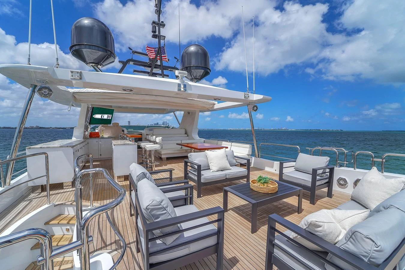 The flybridge offers a spacious outdoor seating area with stunning ocean views. aboard AZIMUT GRANDE 105 Yacht for Sale