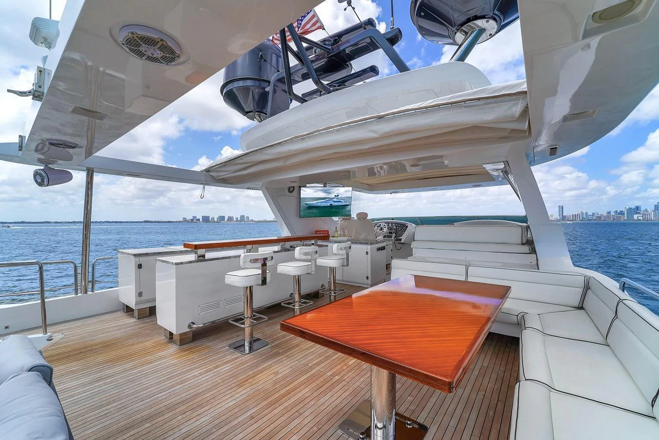 The flybridge offers a spacious and luxurious outdoor area with ample seating and a bar, perfect for entertaining while enjoying panoramic views. aboard AZIMUT GRANDE 105 Yacht for Sale
