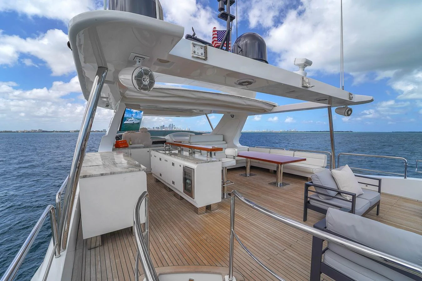 The flybridge offers a spacious and luxurious outdoor area with ample seating and stunning ocean views. aboard AZIMUT GRANDE 105 Yacht for Sale