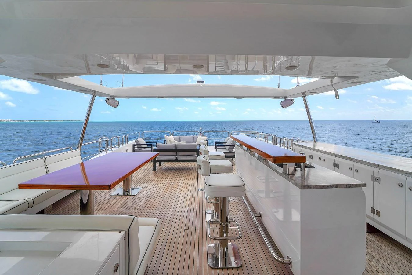 The aft deck offers a spacious and luxurious outdoor seating and dining area with stunning ocean views. aboard AZIMUT GRANDE 105 Yacht for Sale
