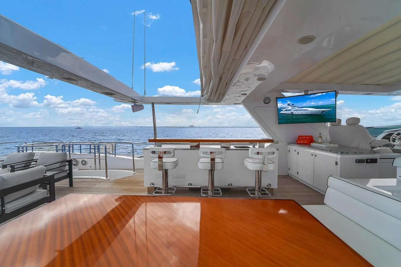 This outdoor bar area provides a perfect spot for relaxation and entertainment with stunning ocean views. aboard AZIMUT GRANDE 105 Yacht for Sale