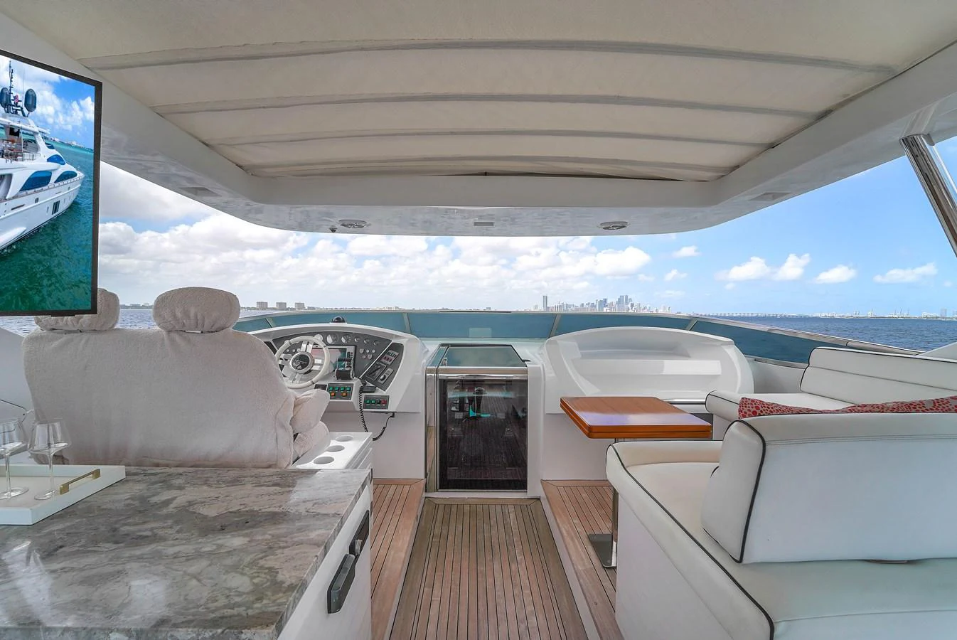 The helm area offers a panoramic view with luxurious seating and modern navigation equipment. aboard AZIMUT GRANDE 105 Yacht for Sale