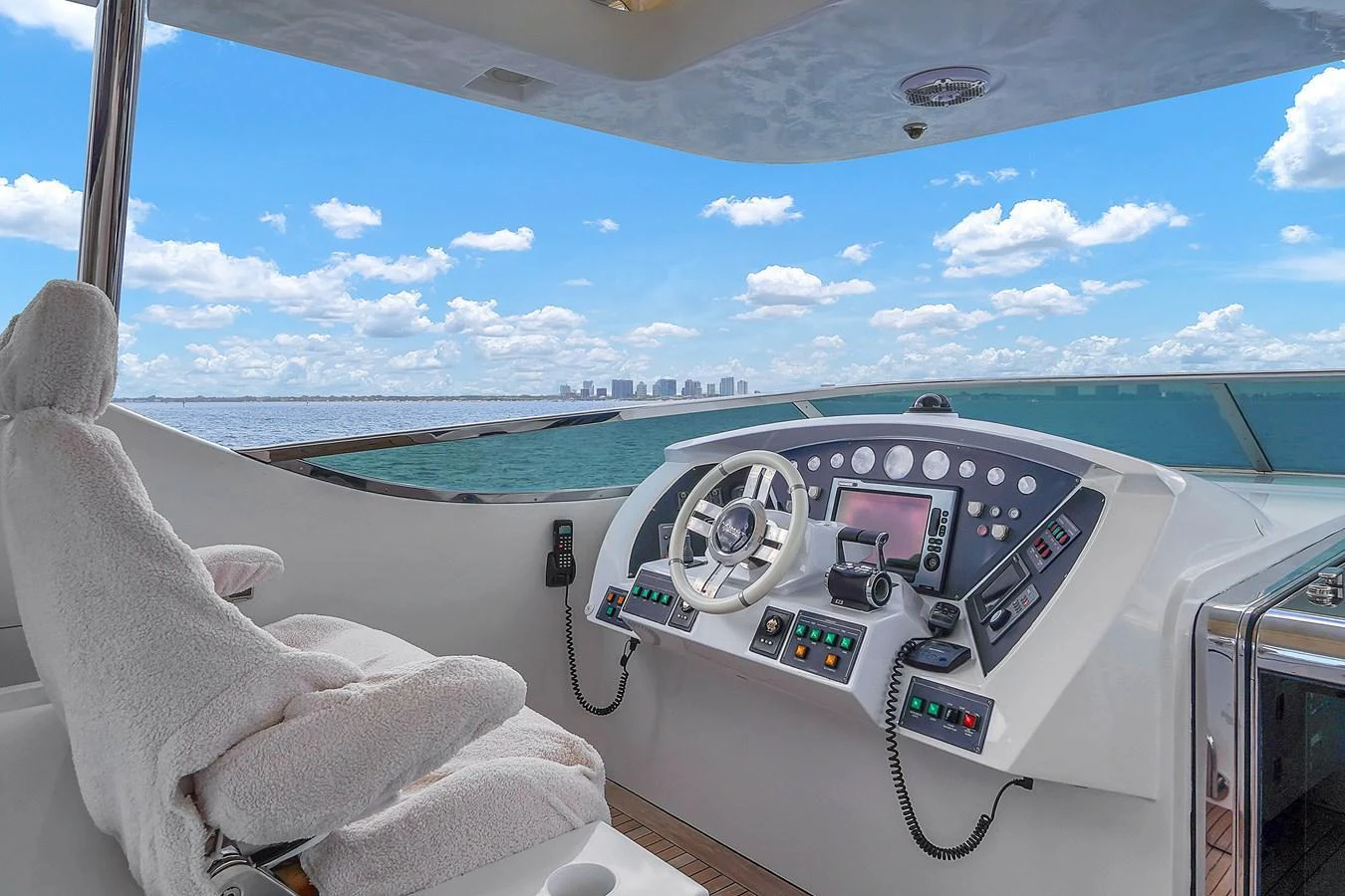 The helm station offers a commanding view with state-of-the-art navigation equipment and a plush captain's chair. aboard AZIMUT GRANDE 105 Yacht for Sale