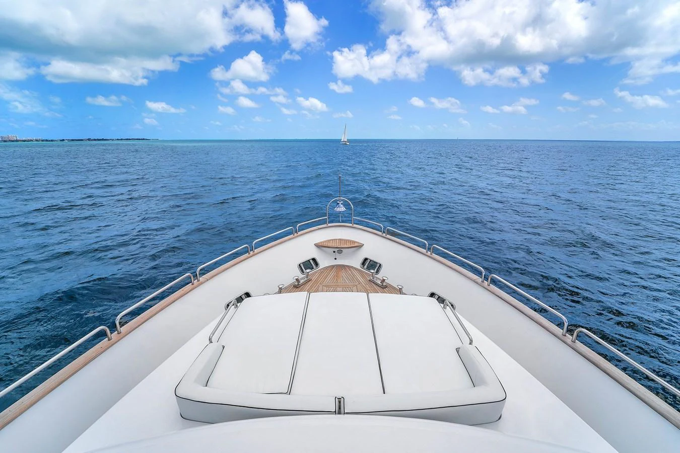 The bow of the yacht offers a serene view of the open sea under a bright blue sky. aboard AZIMUT GRANDE 105 Yacht for Sale