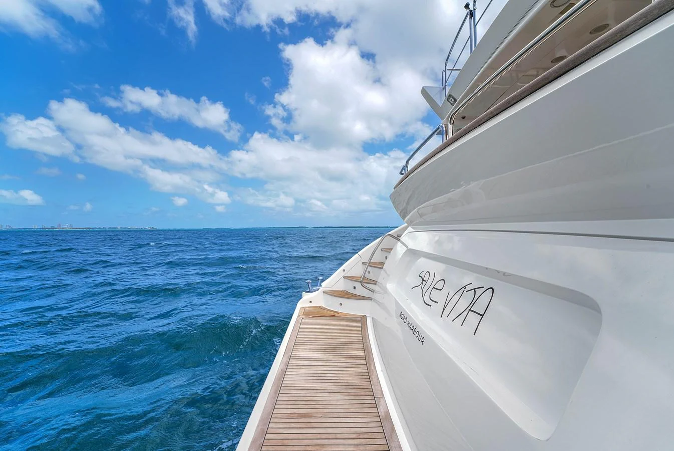 The yacht is shown from the stern, highlighting its sleek design and the surrounding open sea. aboard AZIMUT GRANDE 105 Yacht for Sale