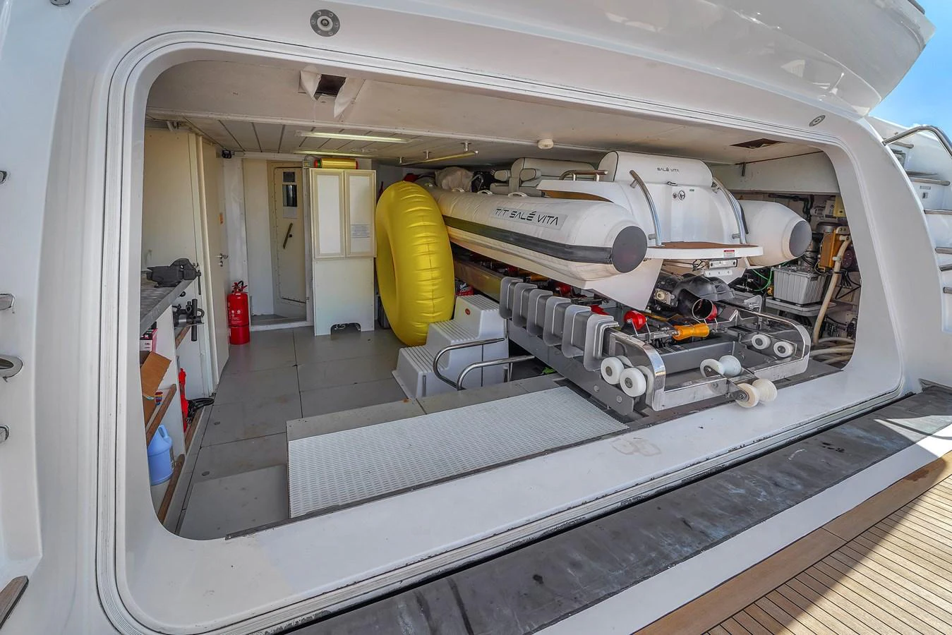 The yacht's tender garage is neatly organized with a tender and various equipment. aboard AZIMUT GRANDE 105 Yacht for Sale