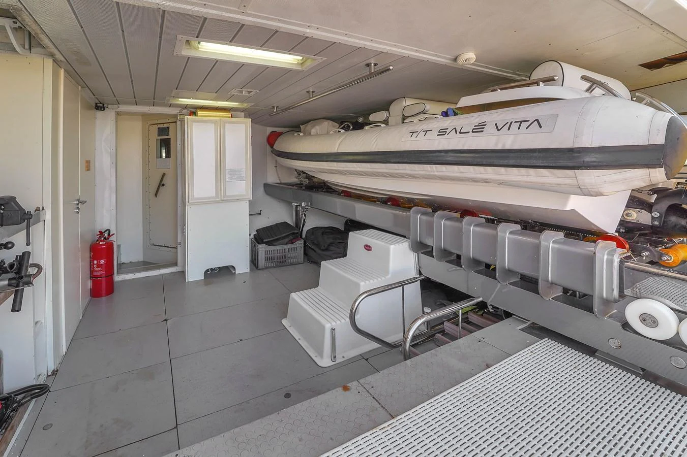 The image showcases a yacht's tender storage area with a neatly secured tender boat. aboard AZIMUT GRANDE 105 Yacht for Sale