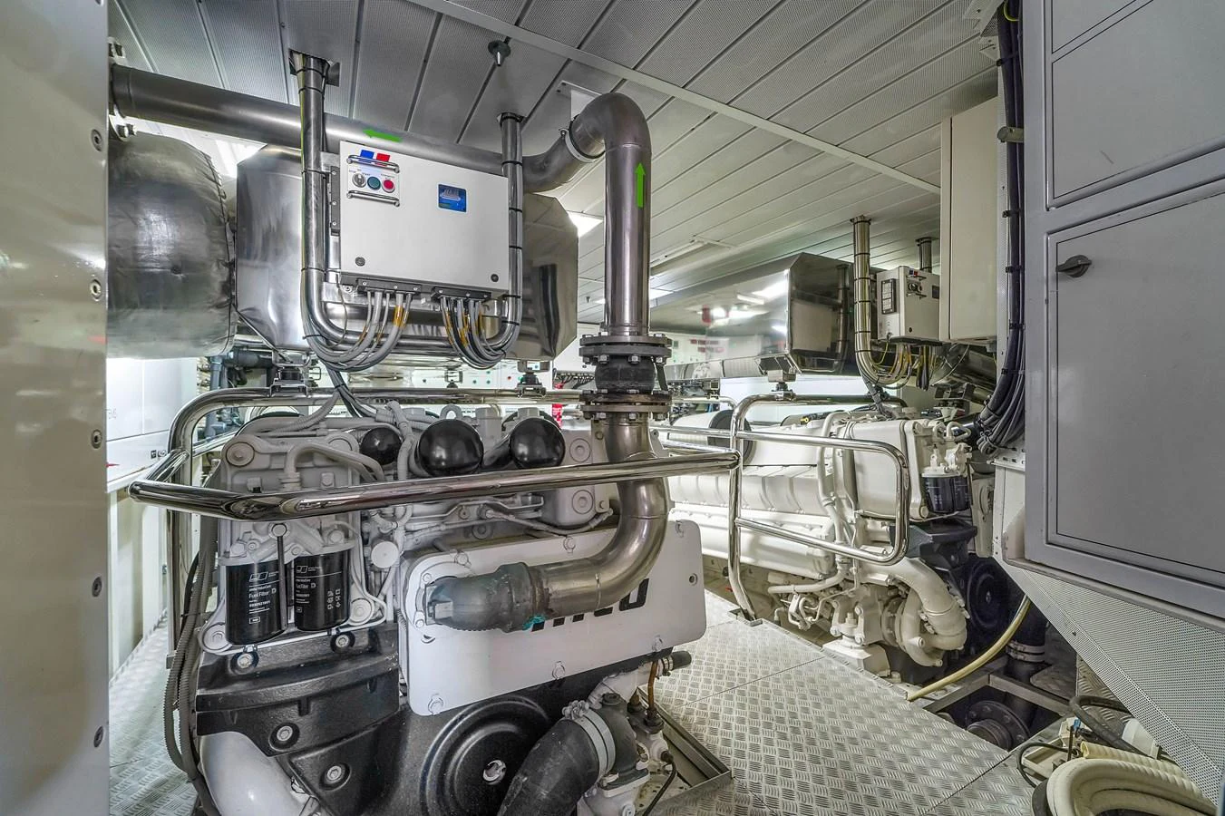 The image showcases the well-maintained engine room of the yacht, highlighting its advanced machinery and clean layout. aboard AZIMUT GRANDE 105 Yacht for Sale