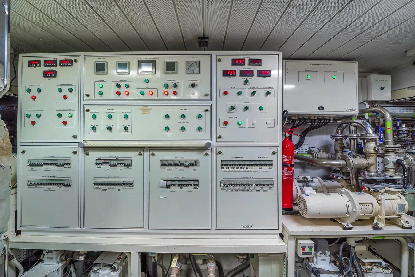 The image showcases the yacht's well-organized and advanced engine room control panel. aboard AZIMUT GRANDE 105 Yacht for Sale