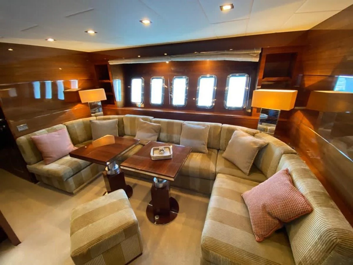 The yacht's salon features a cozy and elegant seating area with plush cushions and warm lighting. aboard SEVEN ZERO Yacht for Sale