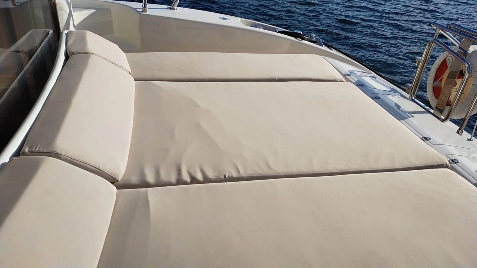 The sundeck offers a spacious and comfortable lounging area with plush cushions, perfect for relaxation. aboard SEVEN ZERO Yacht for Sale