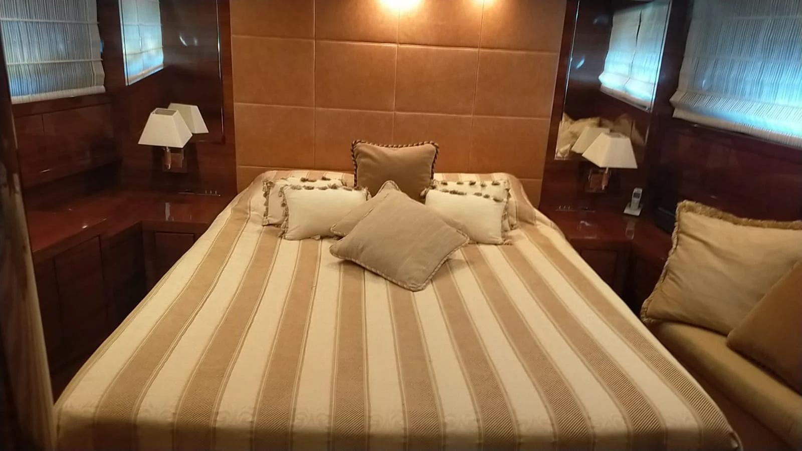 The stateroom features a cozy bed with elegant bedding and soft lighting, creating a warm and inviting atmosphere. aboard SEVEN ZERO Yacht for Sale