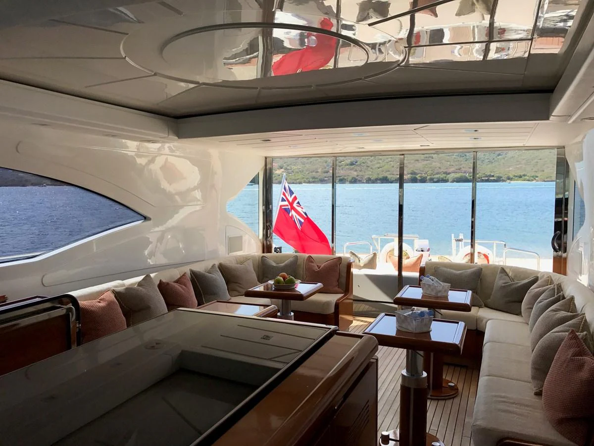 The yacht's salon offers a spacious and comfortable seating area with a view of the water through large windows. aboard SEVEN ZERO Yacht for Sale