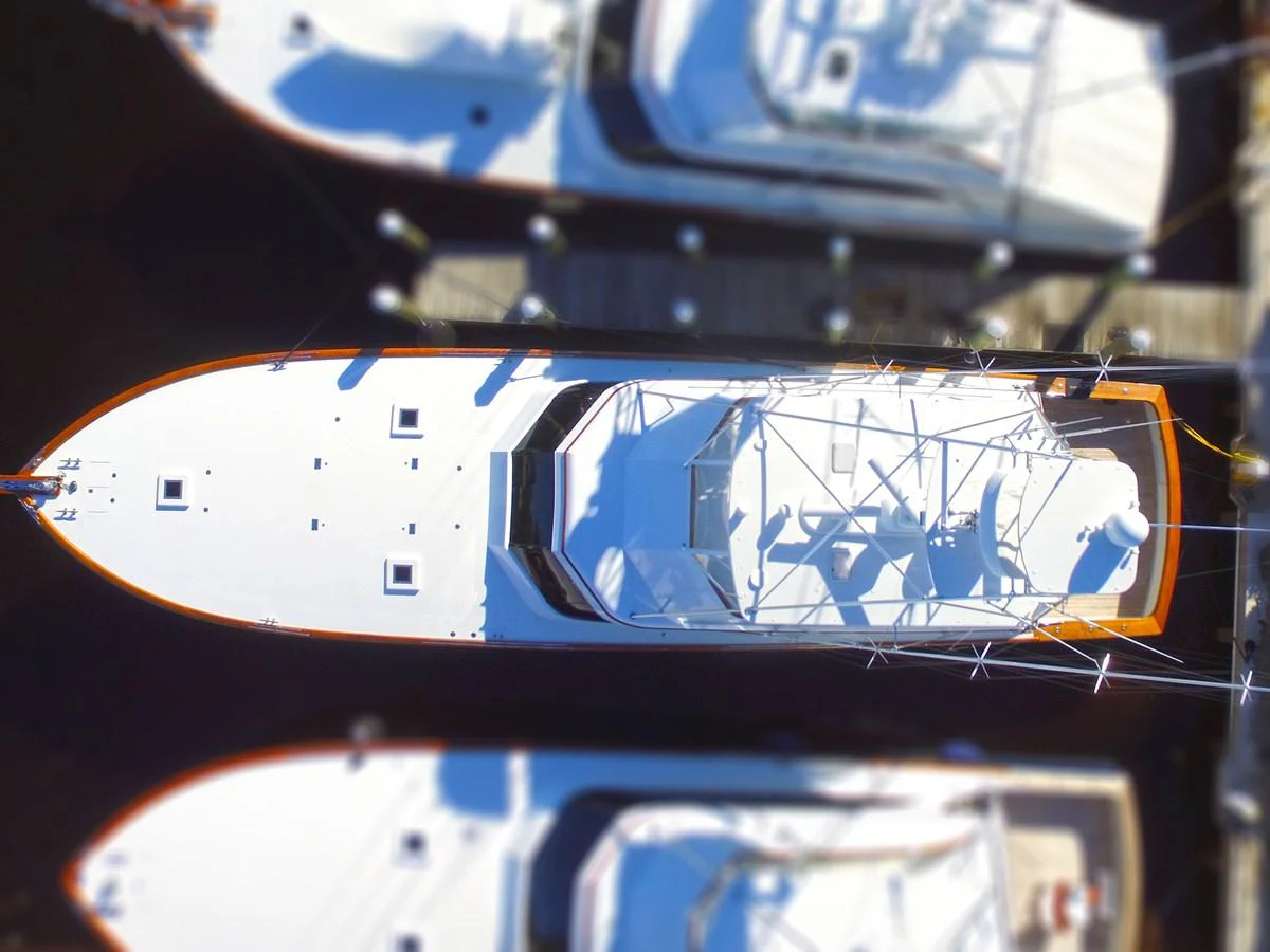 Aerial view of a yacht docked at a marina, showcasing its sleek design and spacious deck. aboard REMAIN CALM Yacht for Sale