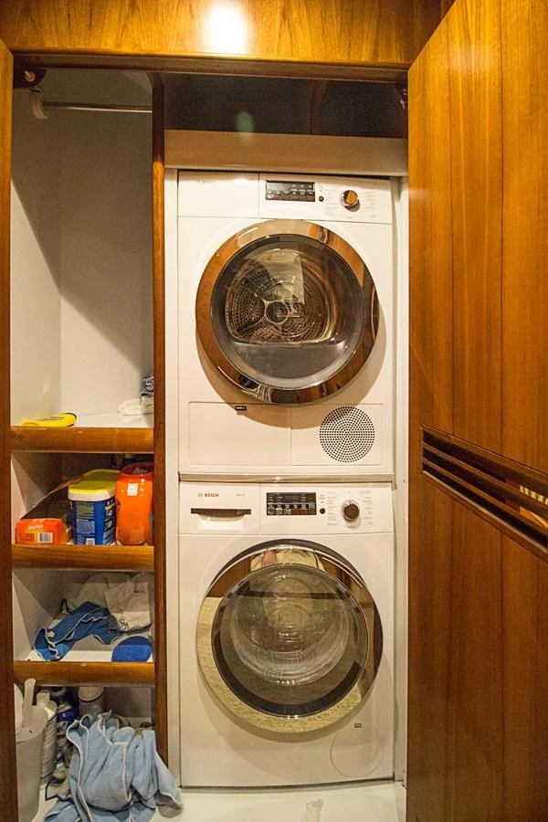 The yacht features a compact and efficient laundry area with modern appliances. aboard REMAIN CALM Yacht for Sale