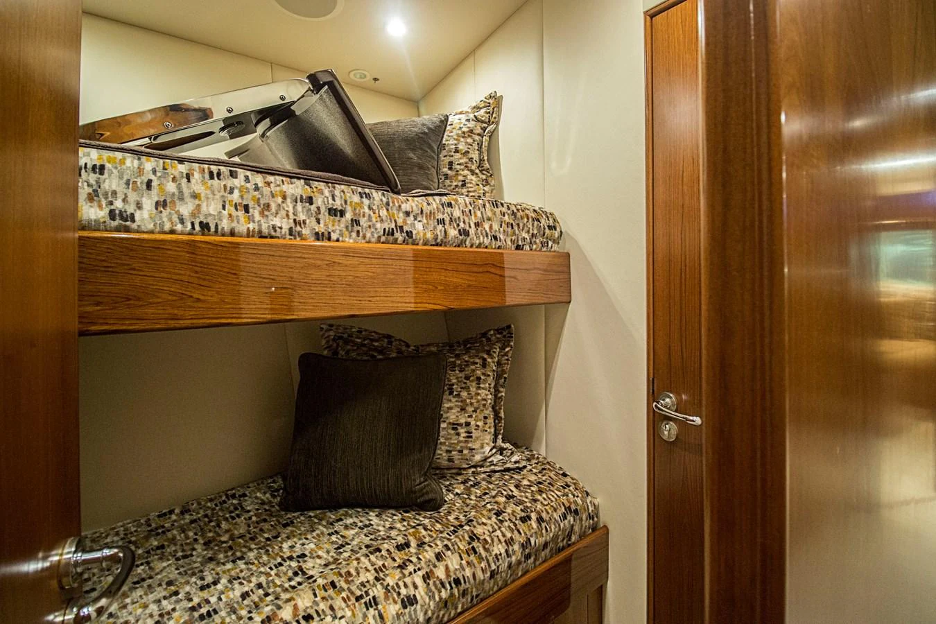 The cozy bunk cabin features comfortable bedding and warm wooden accents. aboard REMAIN CALM Yacht for Sale