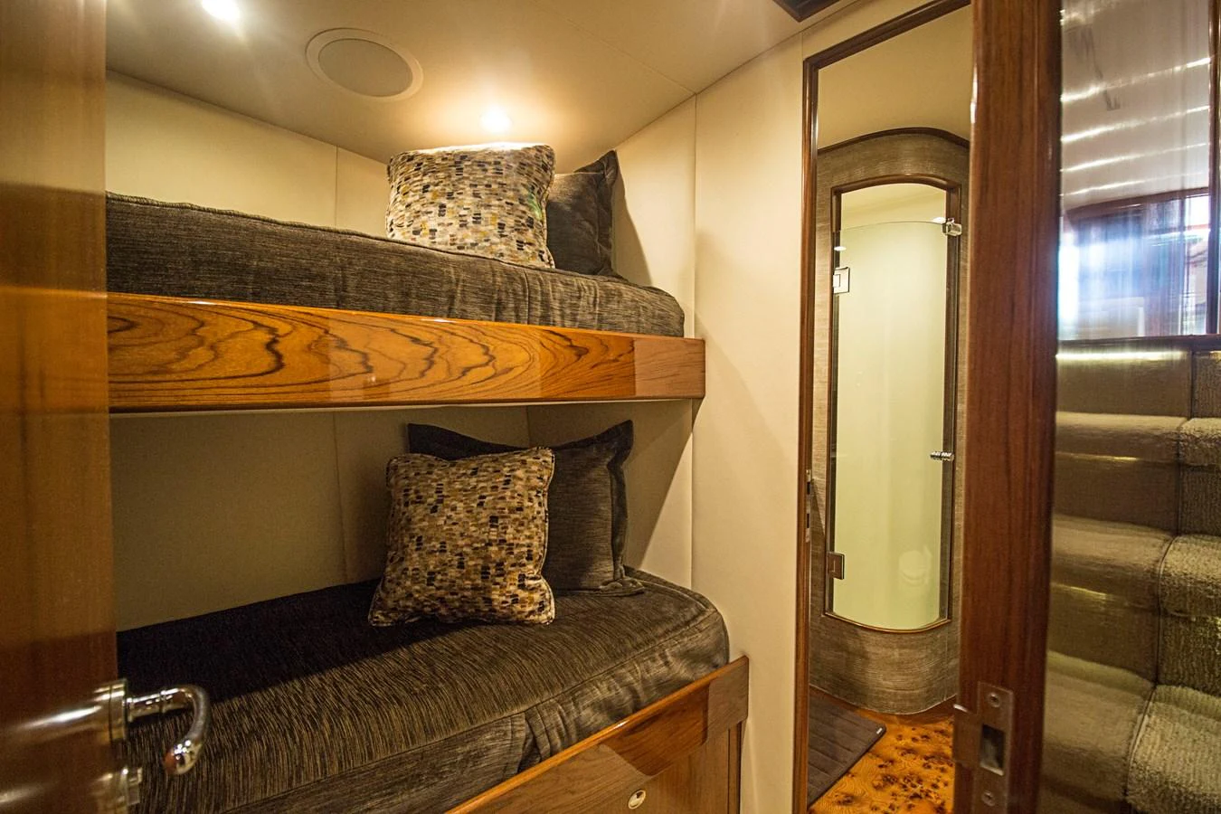 The guest cabin features cozy bunk beds and a private en-suite bathroom. aboard REMAIN CALM Yacht for Sale
