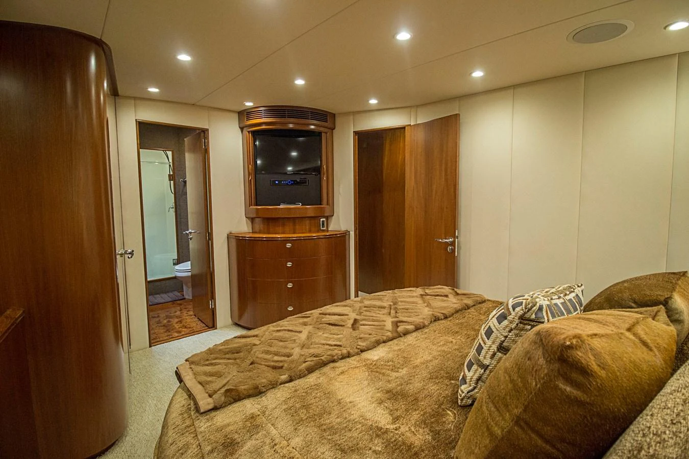 The master stateroom features luxurious wood finishes and plush bedding for ultimate comfort. aboard REMAIN CALM Yacht for Sale