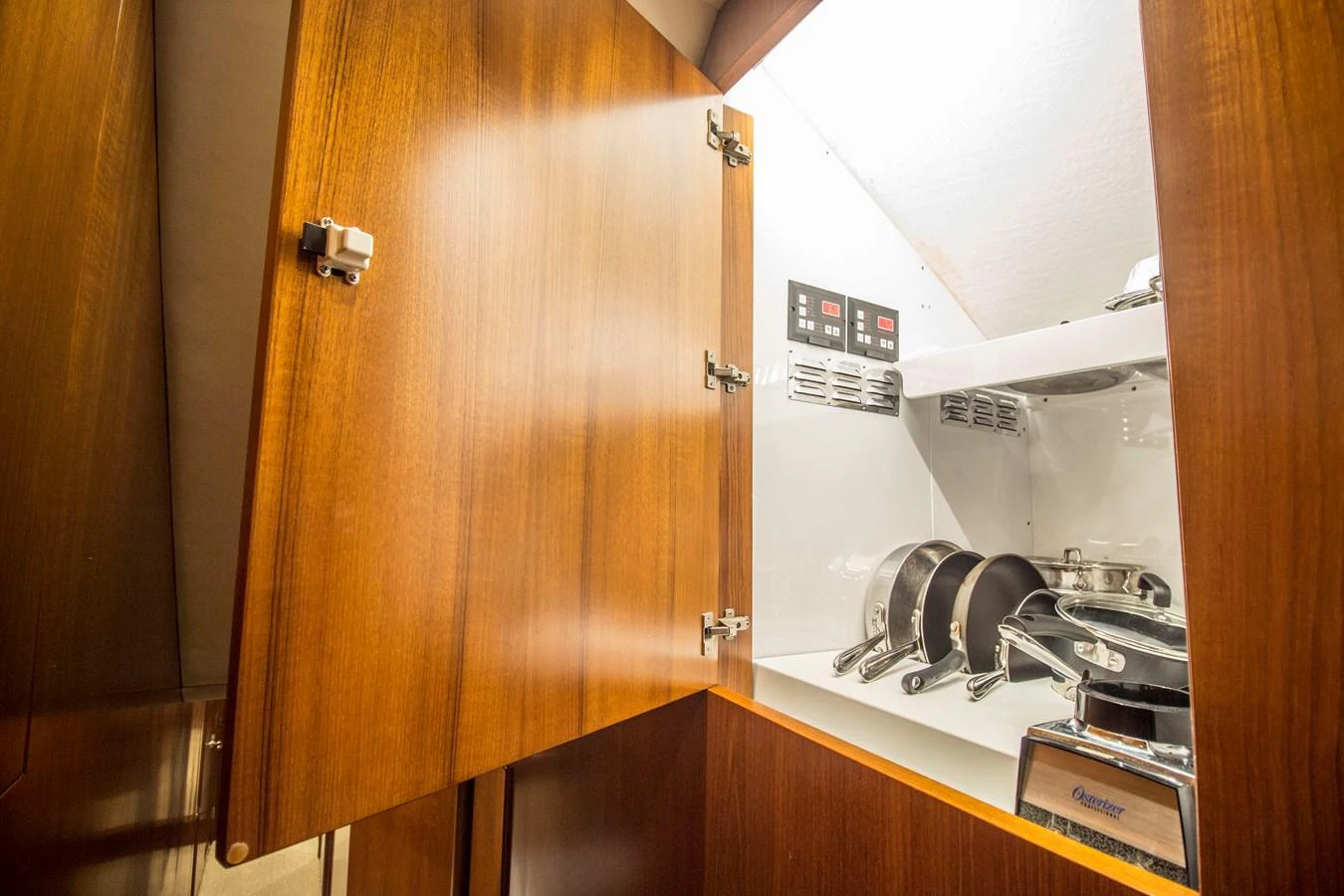 A well-organized galley storage area with neatly arranged cookware and appliances. aboard REMAIN CALM Yacht for Sale