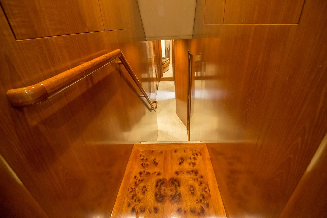 A beautifully crafted wooden staircase leads to the lower deck of the yacht. aboard REMAIN CALM Yacht for Sale