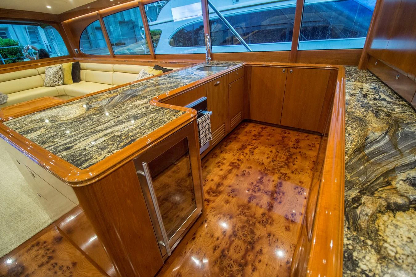 The yacht's galley features luxurious wood finishes and high-end countertops, creating a warm and inviting space. aboard REMAIN CALM Yacht for Sale
