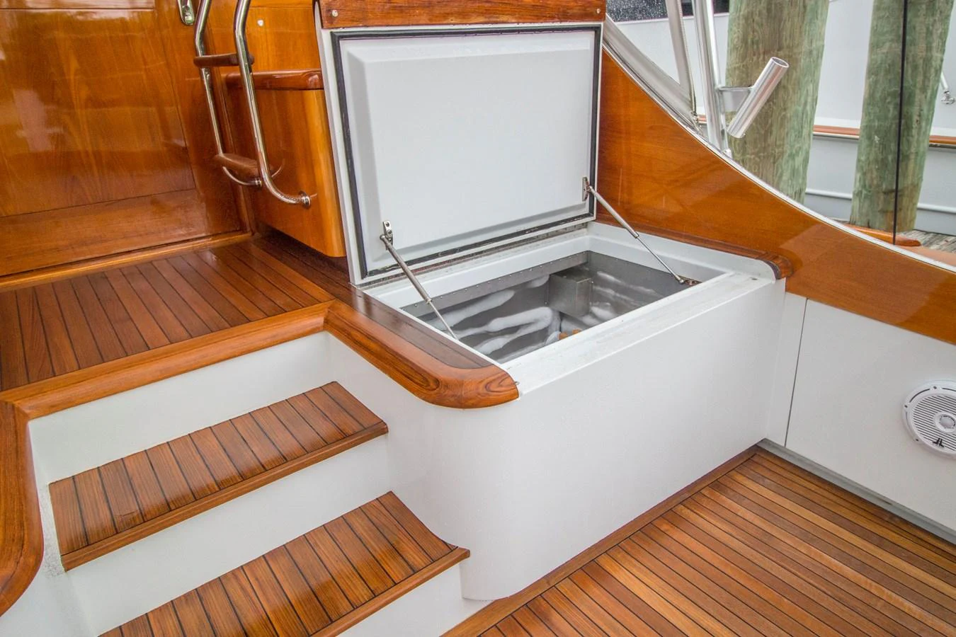 This image showcases a well-crafted wooden staircase leading to a storage compartment on the yacht. aboard REMAIN CALM Yacht for Sale