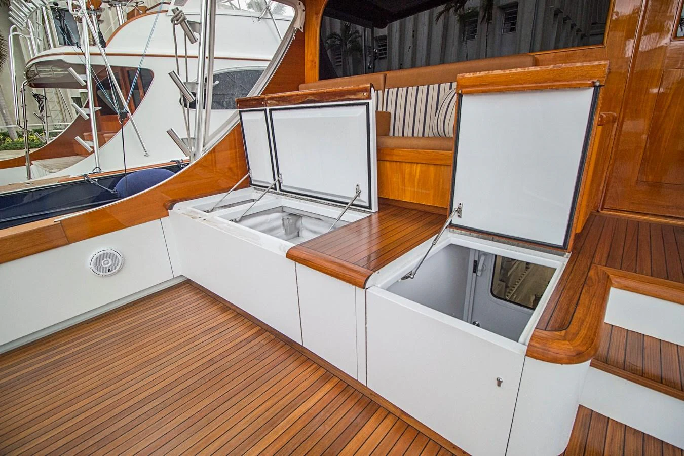 The aft deck features spacious storage compartments with elegant wooden finishes. aboard REMAIN CALM Yacht for Sale