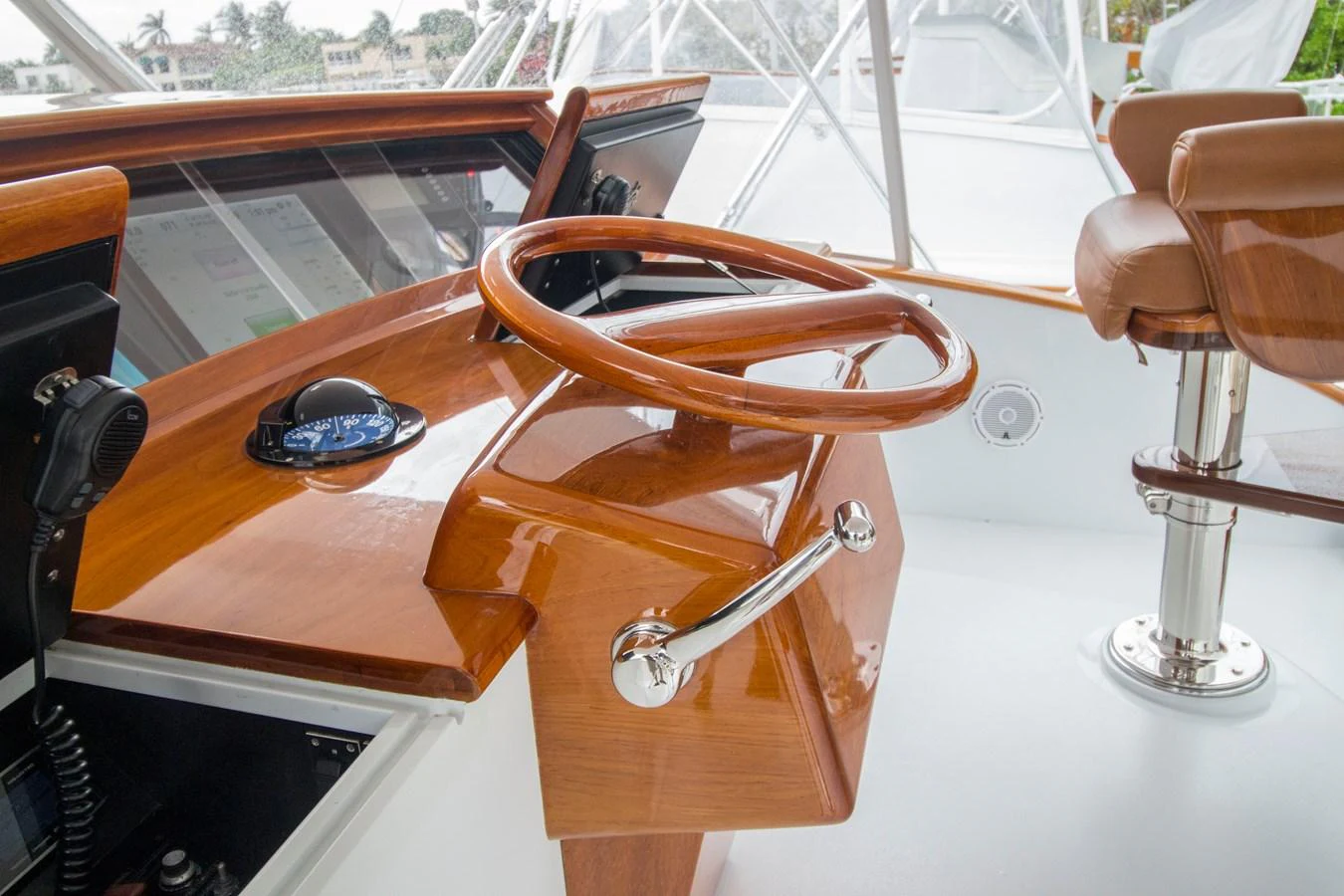 The helm features a polished wooden steering wheel and modern navigation equipment. aboard REMAIN CALM Yacht for Sale