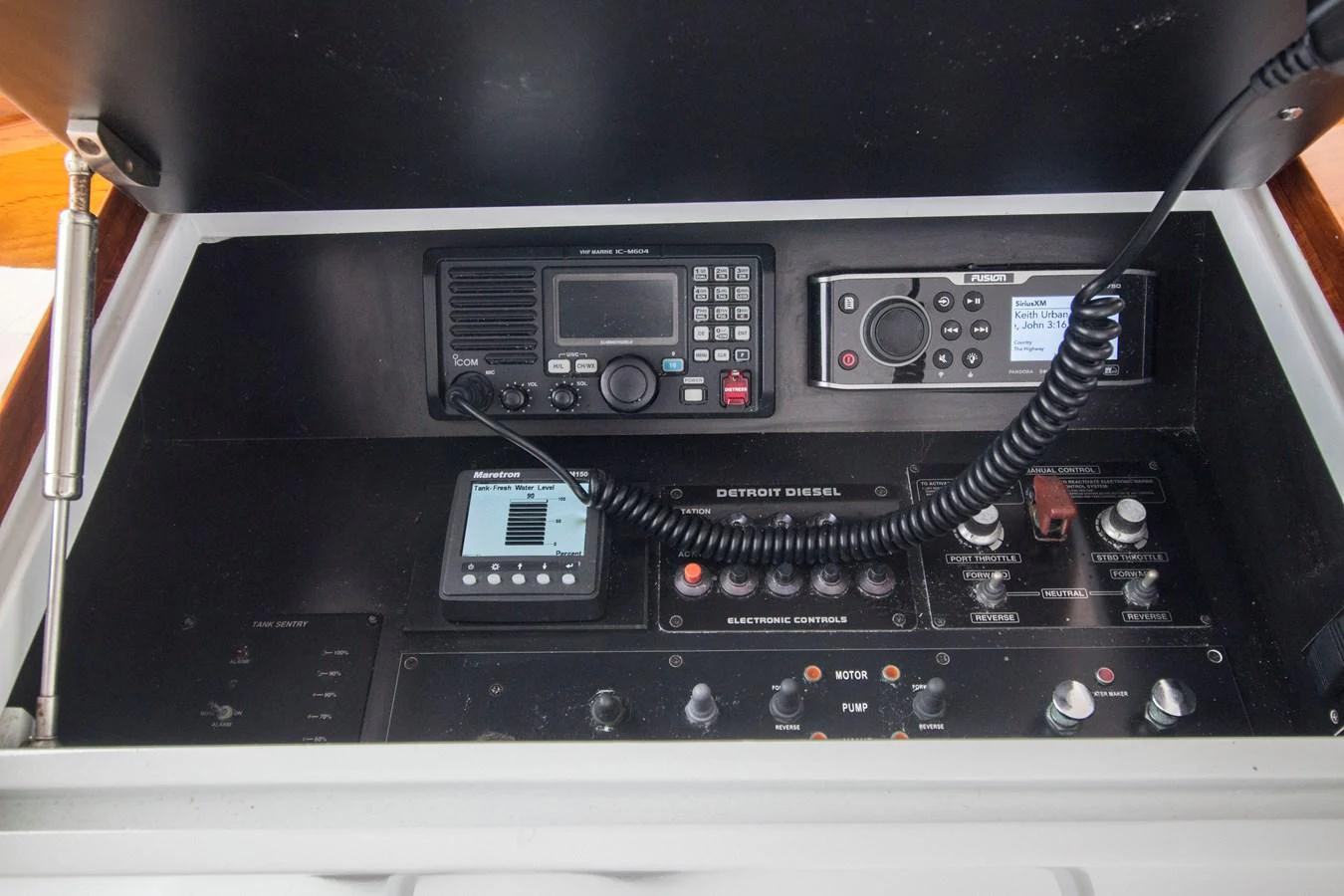 The image showcases the yacht's communication and control panel with various electronic devices. aboard REMAIN CALM Yacht for Sale