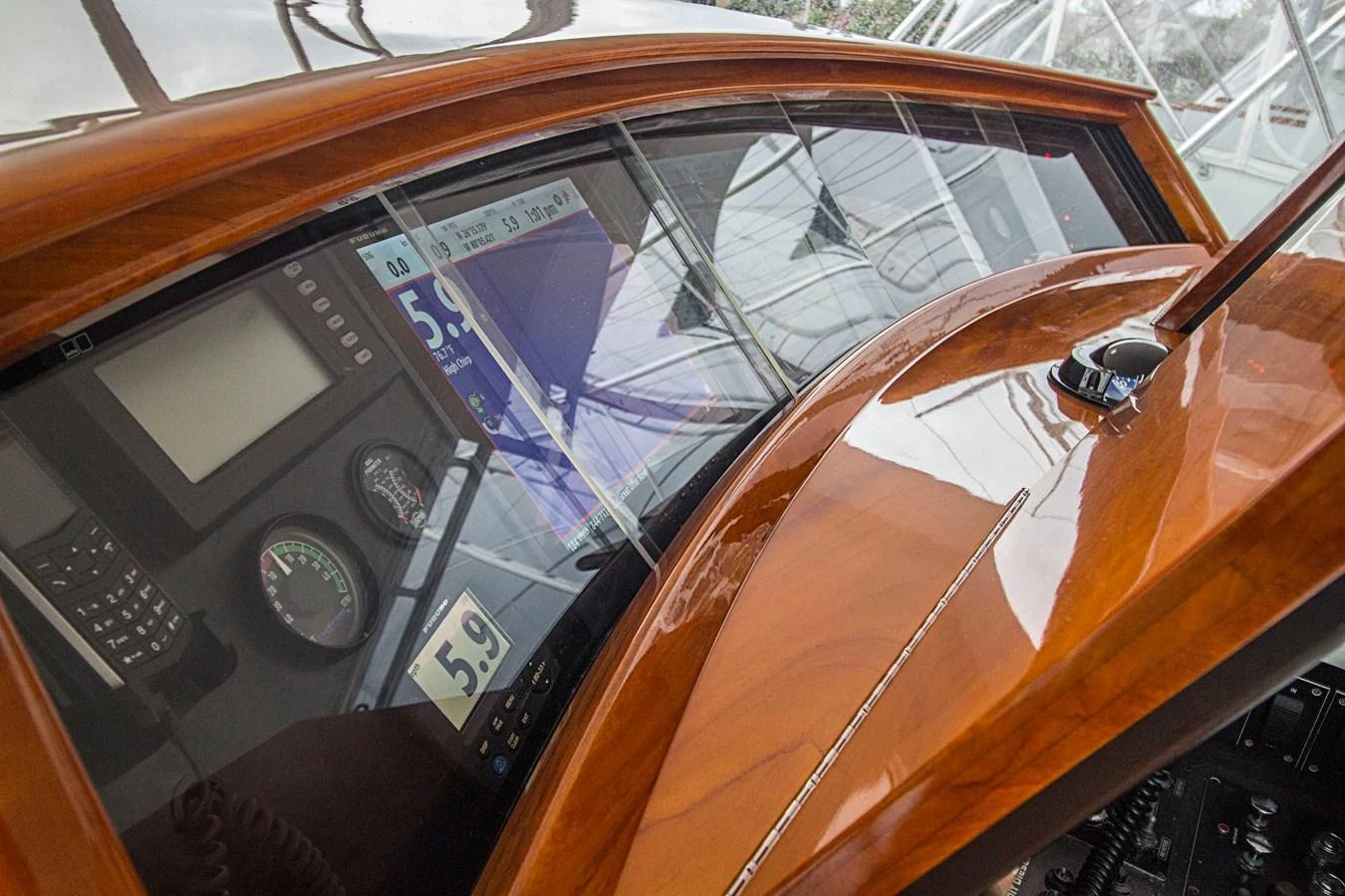 The helm features a sleek, polished wood finish with advanced navigation instruments. aboard REMAIN CALM Yacht for Sale
