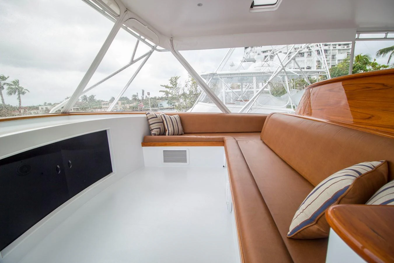 The salon features a comfortable seating area with plush cushions and a sleek, modern design. aboard REMAIN CALM Yacht for Sale