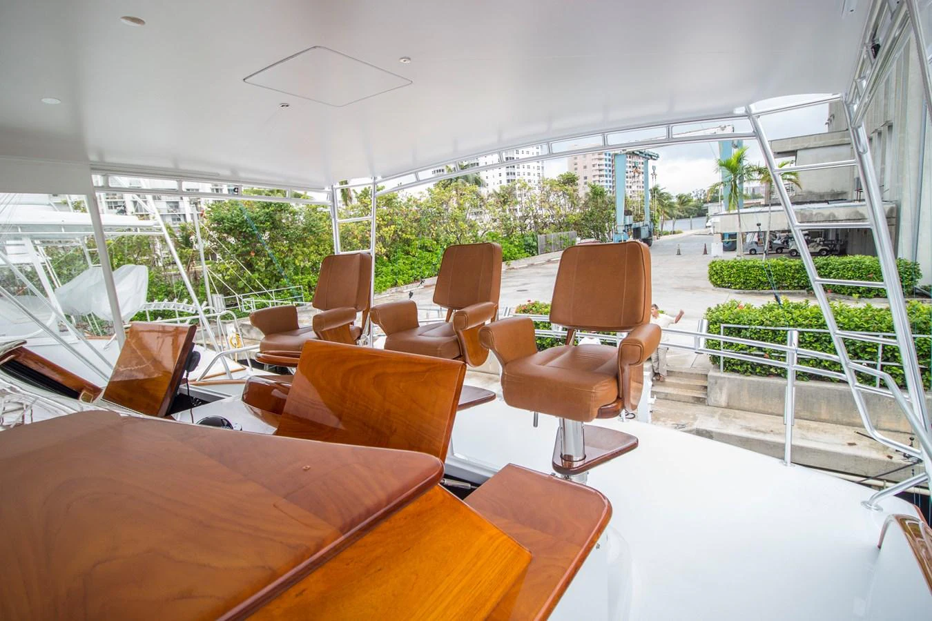 The helm area features luxurious wooden seating with a modern design, offering a comfortable and stylish command center. aboard REMAIN CALM Yacht for Sale