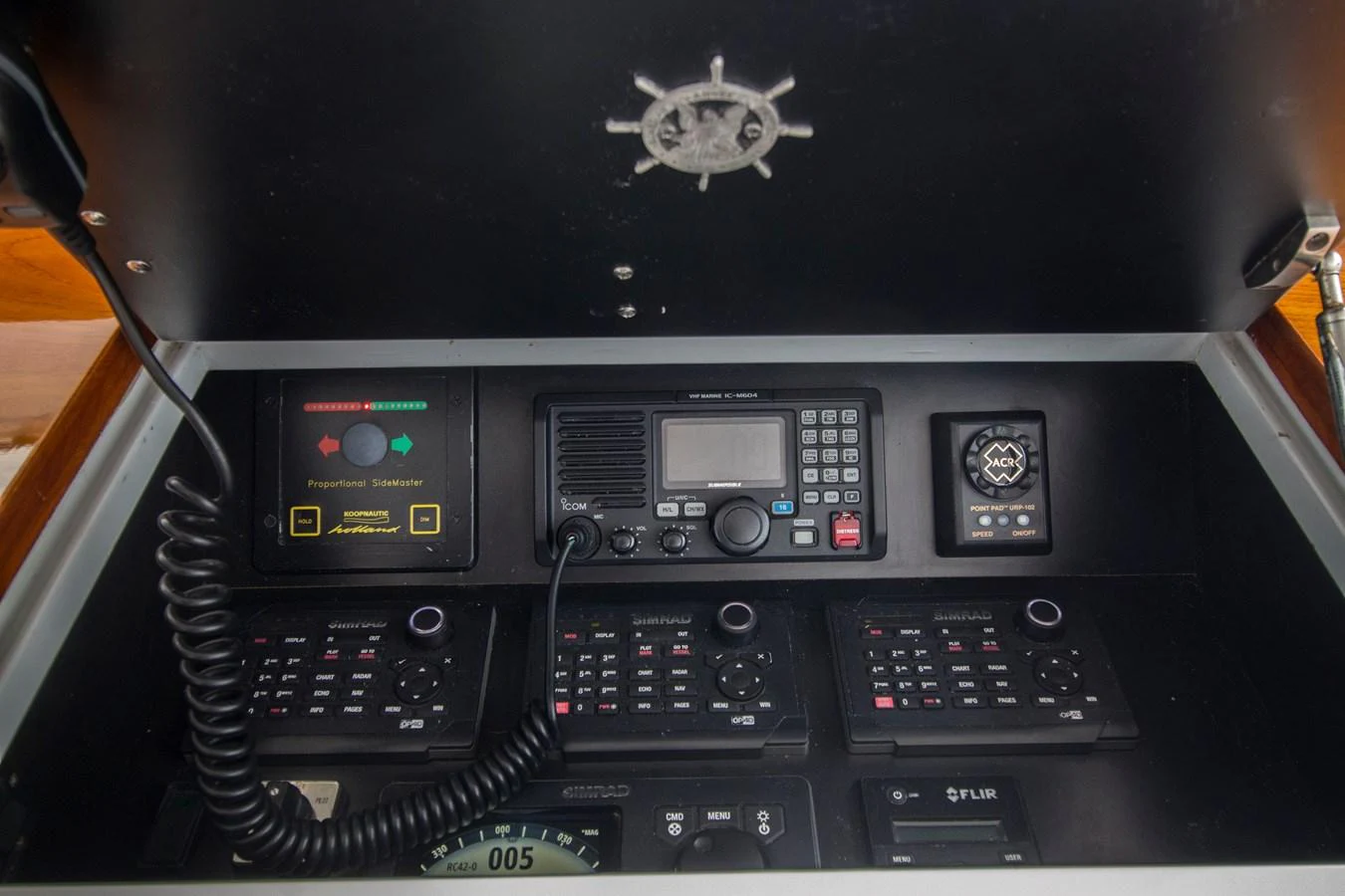 The image showcases the helm station's detailed navigation and communication equipment. aboard REMAIN CALM Yacht for Sale