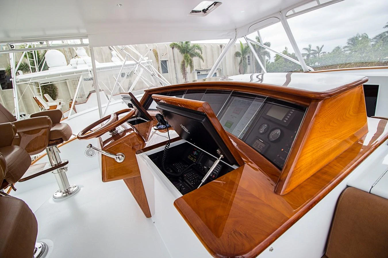 The helm station features polished wood accents and state-of-the-art navigation equipment. aboard REMAIN CALM Yacht for Sale
