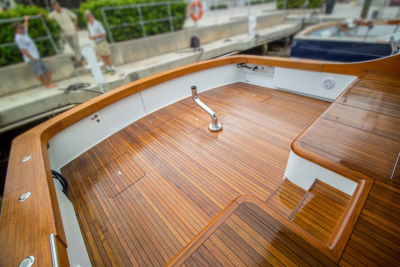 The yacht's aft deck features a beautifully crafted wooden floor, perfect for outdoor relaxation. aboard REMAIN CALM Yacht for Sale
