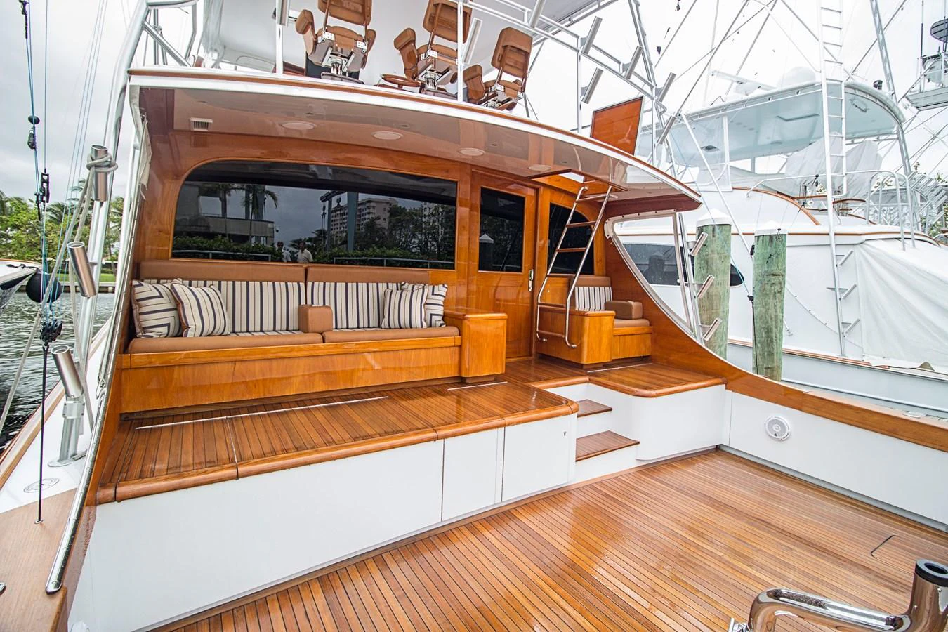 The yacht's aft deck features elegant wooden flooring and comfortable seating, perfect for relaxation. aboard REMAIN CALM Yacht for Sale