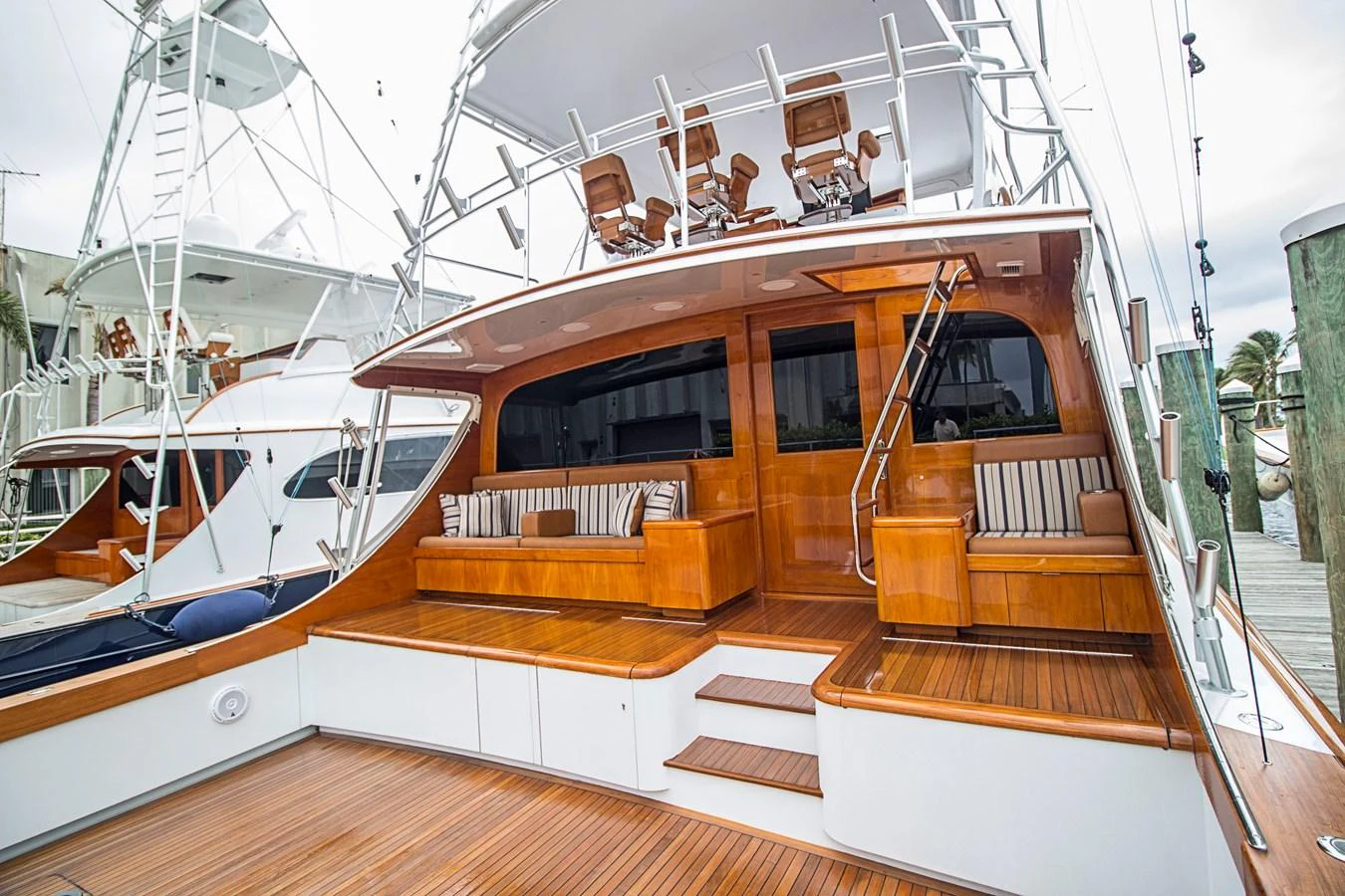 The yacht's aft deck features elegant wooden finishes and comfortable seating areas. aboard REMAIN CALM Yacht for Sale