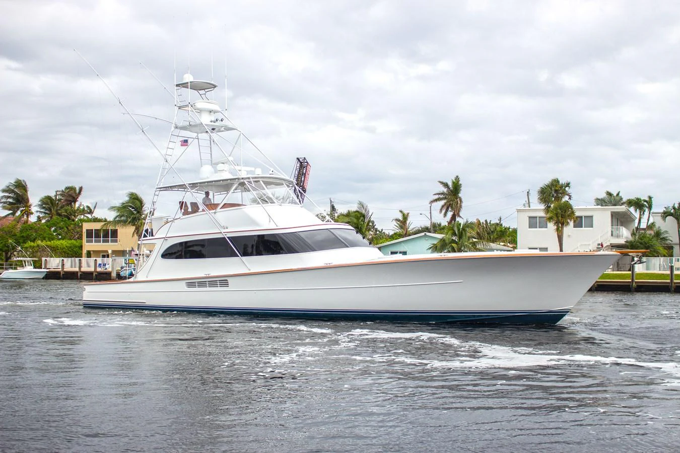 A sleek yacht cruises through calm waters, showcasing its elegant design and modern lines. aboard REMAIN CALM Yacht for Sale