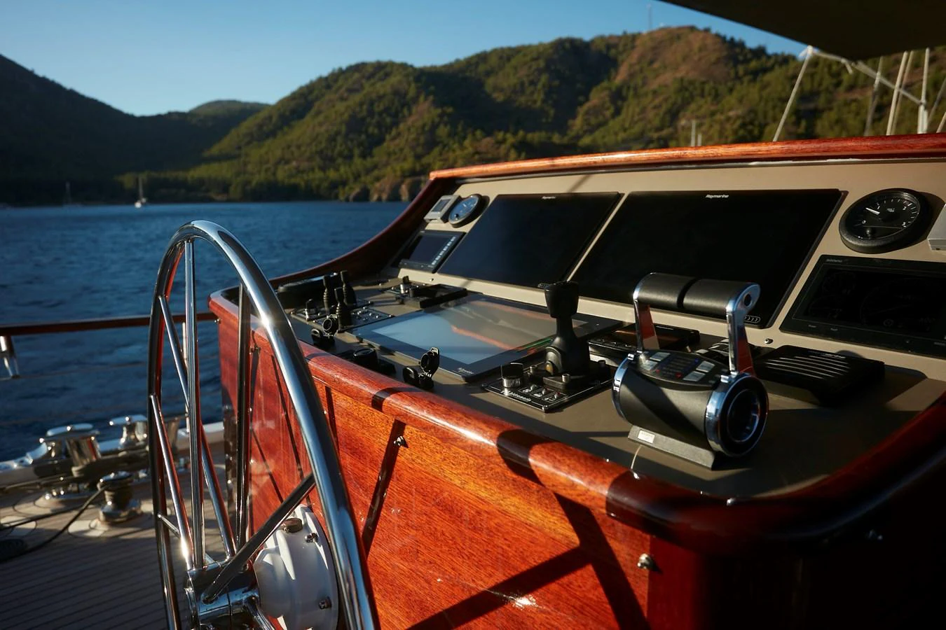 The helm station features advanced navigation equipment and a polished wooden console. aboard WHITE WINGS Yacht for Sale