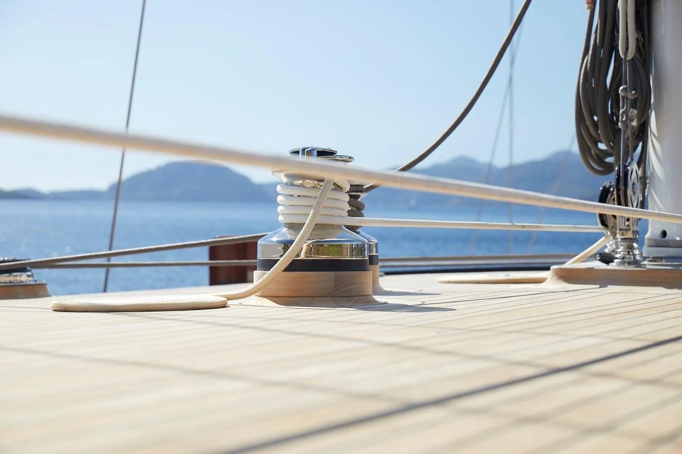 A close-up view of the yacht's deck showcasing the winch and rigging against a serene ocean backdrop. aboard WHITE WINGS Yacht for Sale