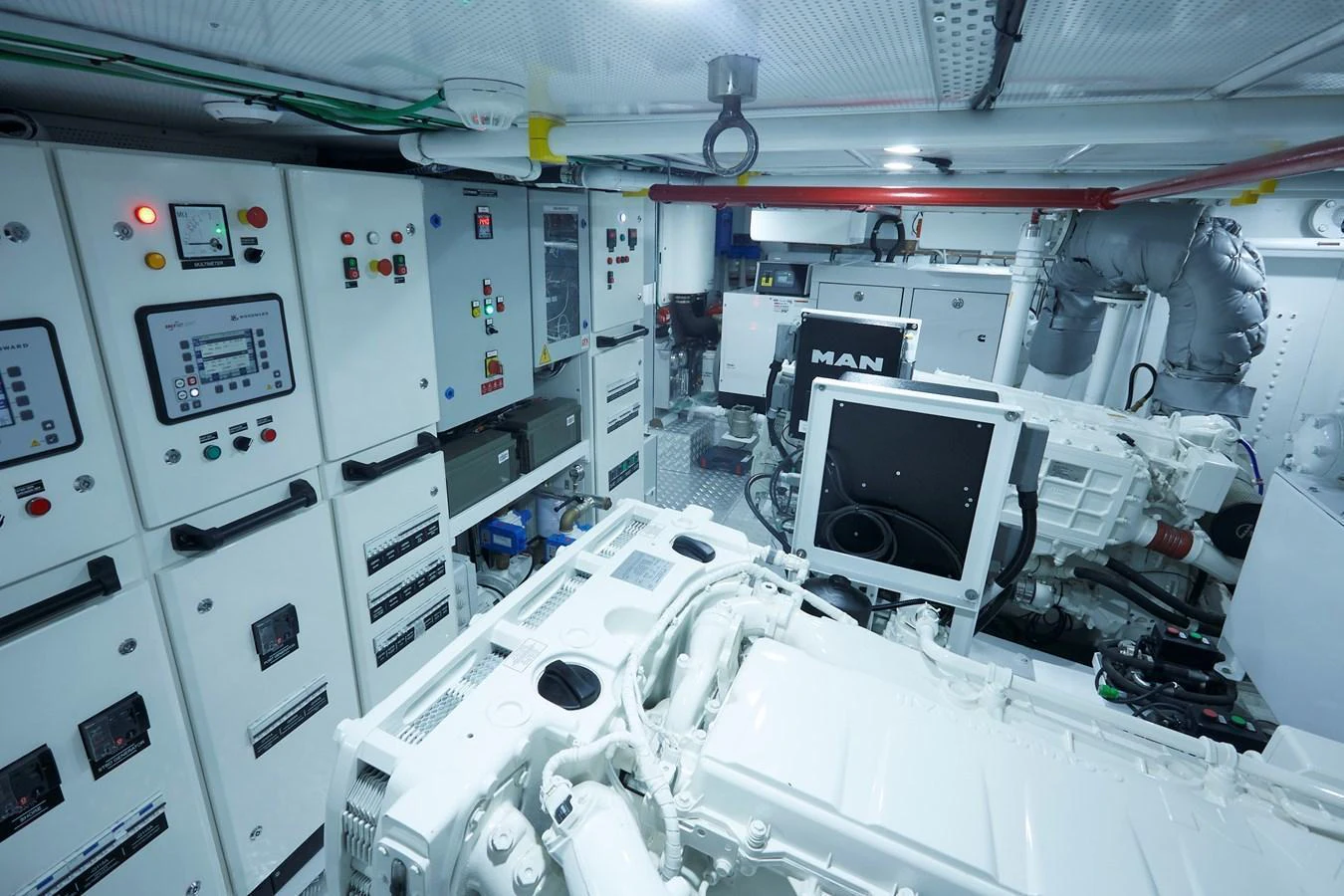 The image showcases the well-equipped engine room of the yacht, featuring advanced machinery and control panels. aboard WHITE WINGS Yacht for Sale