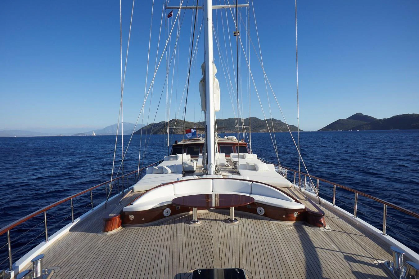 The foredeck of the yacht offers a spacious and inviting area for relaxation, with stunning views of the surrounding waters and distant islands. aboard WHITE WINGS Yacht for Sale