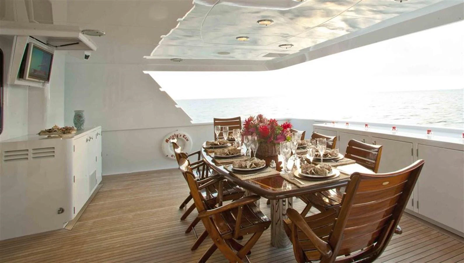 a dining room with a table and chairs aboard MURPHY'S LAW Yacht for Sale