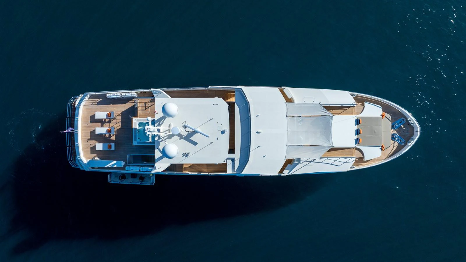 An aerial view of a luxurious yacht showcasing its sleek design and spacious deck areas. aboard NYLA Yacht for Sale